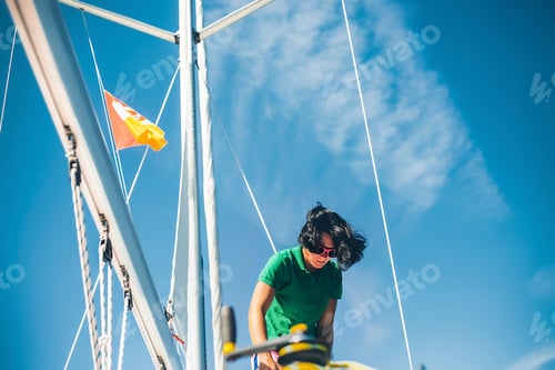Preview: Woman working on ropes on sail boat