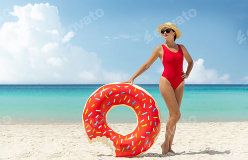 Preview: Beautiful woman with inflatable donut