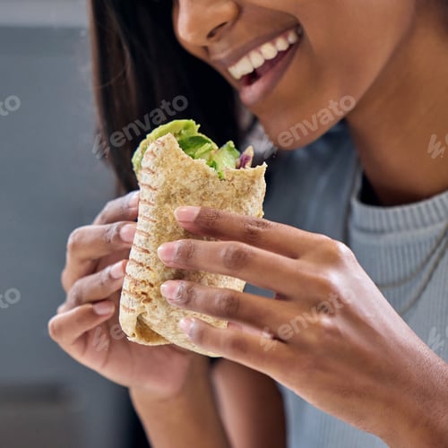 Preview: Being healthy has never been so delicious. Shot of a woman enjoying a wrap.