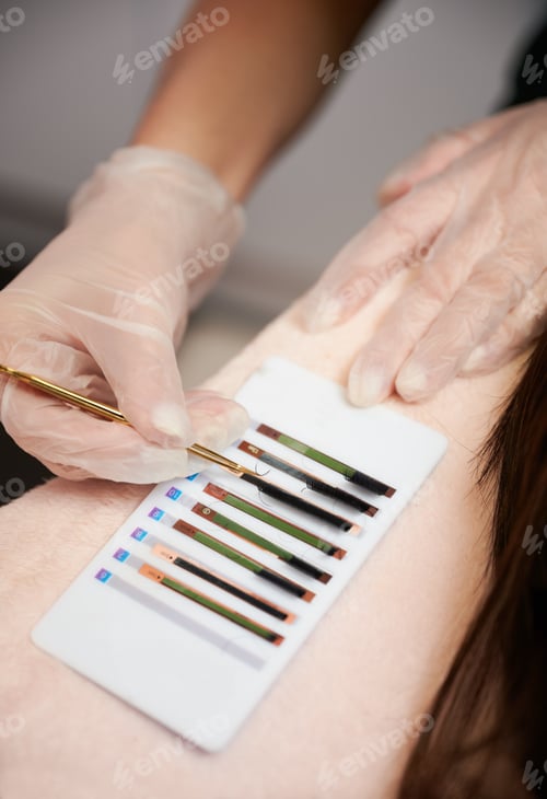 Preview: Lash technician hand picking up eyelashes with tweezers.