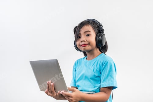 Preview: Little girl using laptop computer and listening lesson online