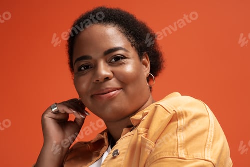 Preview: Stylish plus size woman showcasing trendy autumn fashion in vibrant studio setting