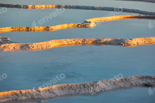 Preview: Pamukkale white mineral limestone natural pool at sunset. Turkey