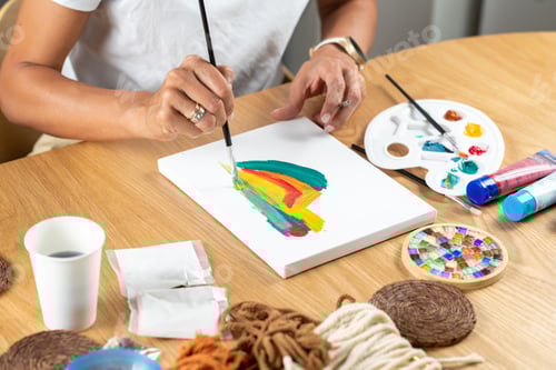 Preview: Woman painting in a simple home studio environment.