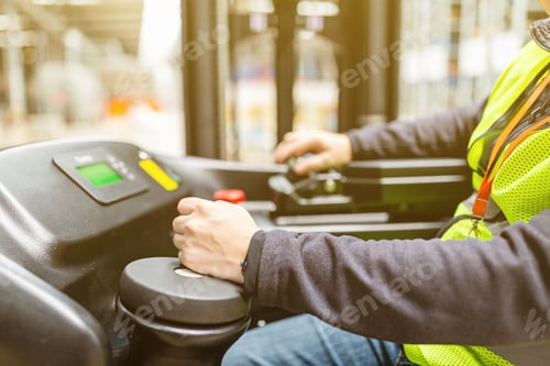 Preview: Storehouse employee in uniform working on reachtruck in modern automatic warehouse
