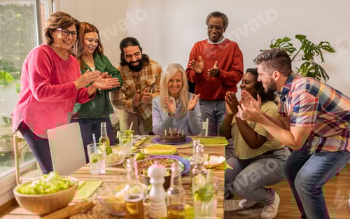Preview: Group of friends clapping hands celebrating birthday at home