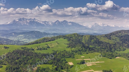 Preview: Aerial drone view over green hills of Pieniny National Park and snowy Tatra Mountains
