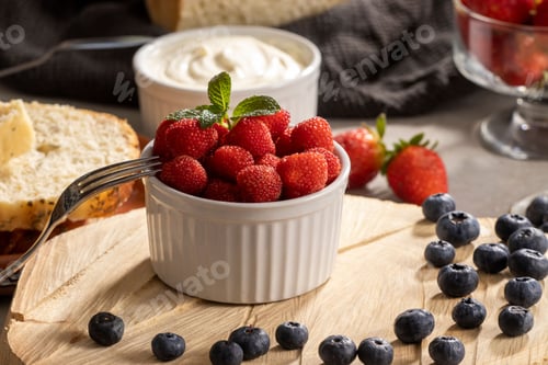 Preview: A wooden board with a bowl of delicious red raspberries