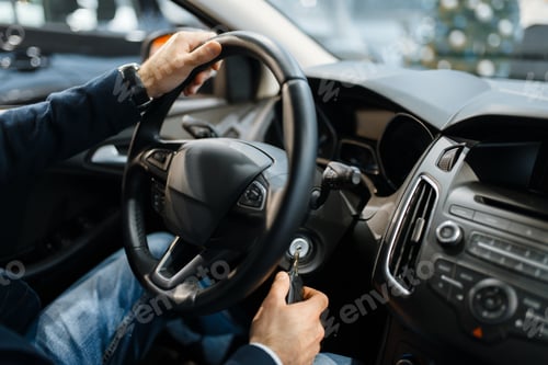 Preview: Male person behind the wheel of new automobile