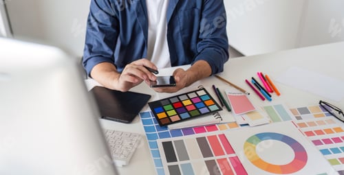 Preview: Graphic Designer Selecting Color Pairs on Computer for Creative Design Projects in Modern Workspace
