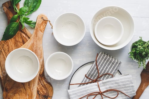 Preview: Kitchen utensils on a white table in a modern kitchen. Place for text. Top view.