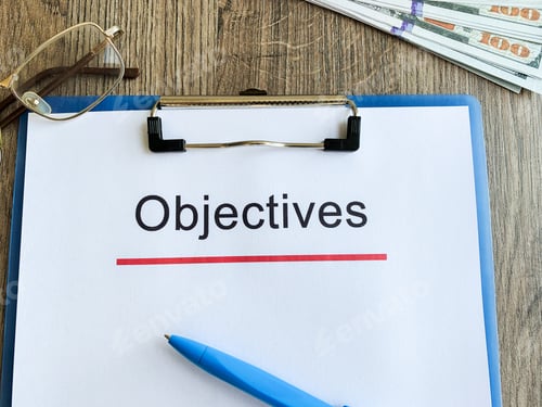 Preview: Paper with text objective on wood table.