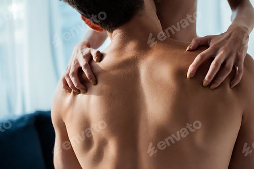 Preview: cropped view of passionate woman scratching back of man