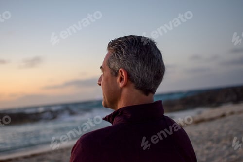 Preview: Man at the beach looking at the Sunset