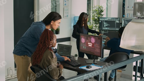 Preview: Diverse team of app developers having computer hacked and writing code