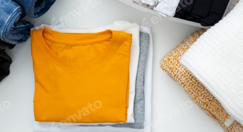 Preview: Neatly Folded Colorful Clothes on a White Background