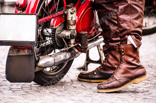 Preview: Unidentified biker with a vintage motorcycle at motorcycle festival