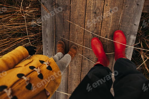 Preview: Dad and child Feet Walking Along a Wooden Path in Nature Park