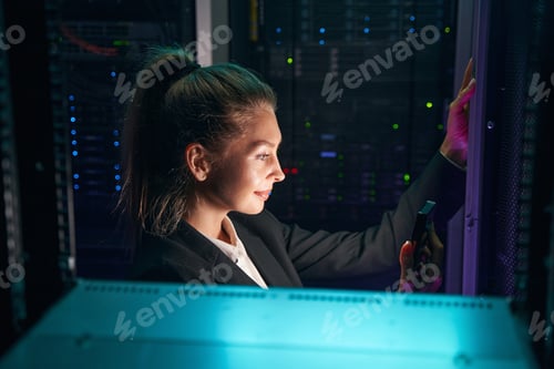 Preview: IT technician working with servers in data center