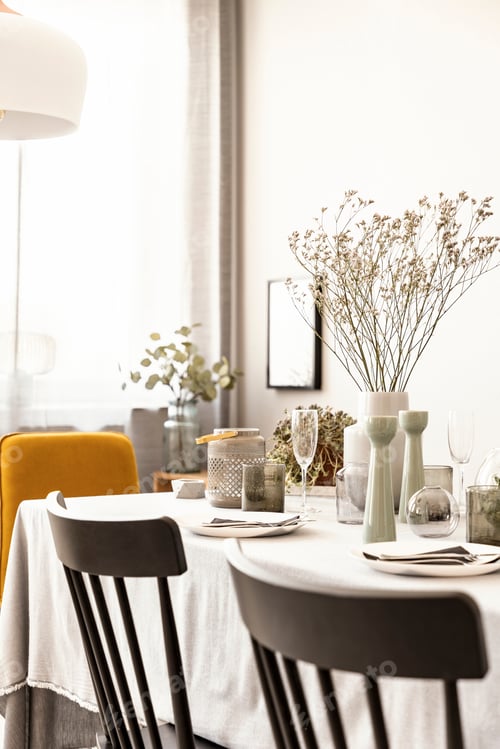 Preview: Close-up of chairs and table with flower and tableware in a dini