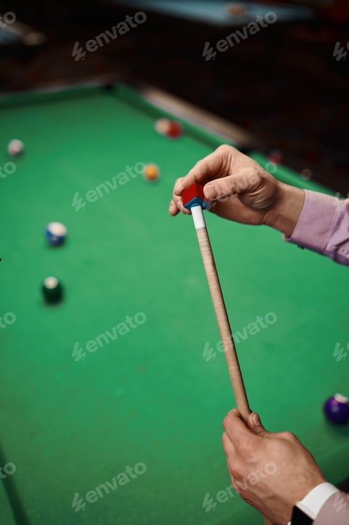Preview: Closeup man billiard player rubbing cue