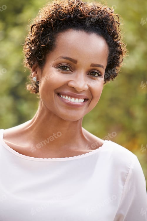 Preview: Young African American woman looks to camera, vertical