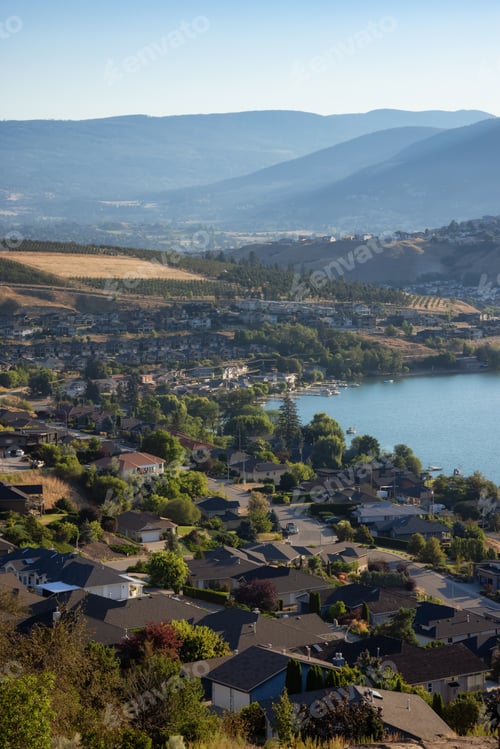 Preview: Scenic View of Kalamalka Lake and a small City during sunny summer sunrise.