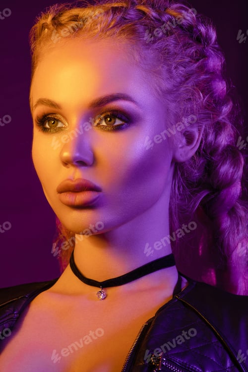Preview: Gorgeous fashionable woman in the lights. pink and yellow light