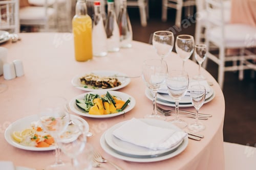Preview: Wedding setting, tender pink table with glasses, cutlery, napkin and delicious food and drinks