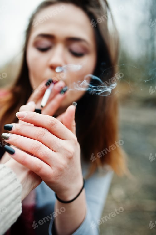 Preview: Hand of girl with cigarette lighter. Stop smoking social problem. Friends smoke.
