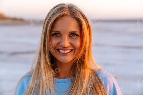 Preview: Young caucasian happy woman smiling and looking at camera outdoors