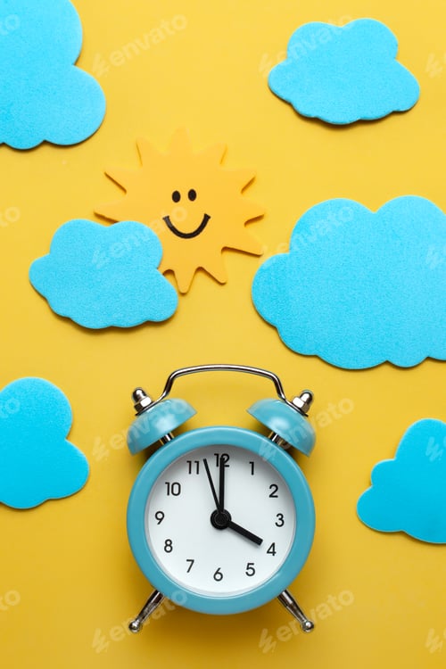 Preview: Blue round alarm clock, sun and clouds on the yellow background.
