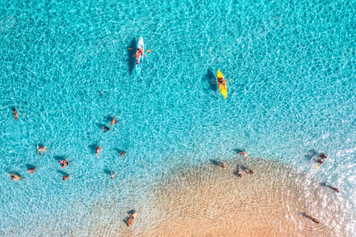 Preview: Aerial view of kayaks, swimming people in blue sea, sandy beach