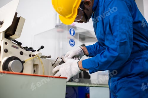 Preview: experienced operator technician worker working or repair on metal machine