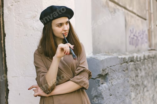 Preview: Girl in dress and black hat with painting brush in her hands