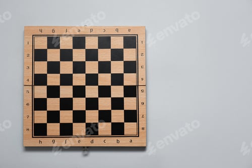 Preview: Empty wooden checkerboard on light grey background, top view. Space for text