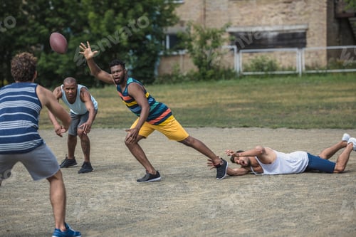 Preview: group of young multicultural men playing football on court