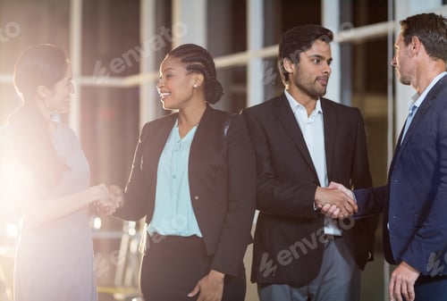 Preview: Group Of Businesspeople Shaking Hands With Each Other In The Office