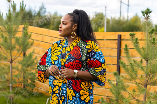 Preview: Summer portrait of beautiful african american woman in colourful dress wear standing on backyard