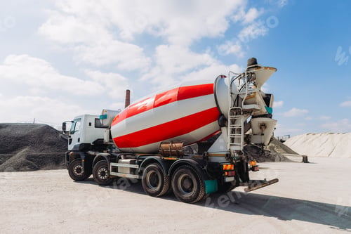 Preview: Concrete mixer truck parked at production plant on sunny day