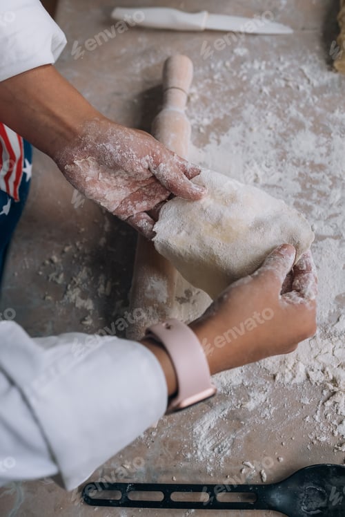 Preview: Smiling woman in kitchen holding cute white Maltese dog