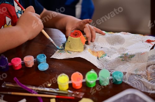 Preview: Close up view of child's hands painting