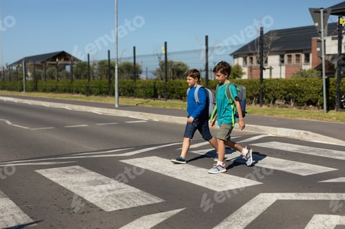Preview: Two schoolboys crossing the road on a pedestrian crossing