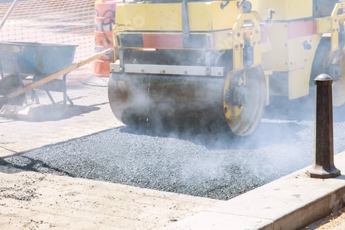 Preview: Worker repairs damaged portion of a reconstruction street