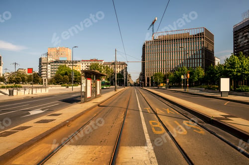 Preview: A serene urban scene with empty tram tracks leading into the distance on a sunny day.