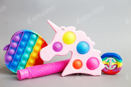 Preview: colorful antistress sensory fidget toys on a gray background
