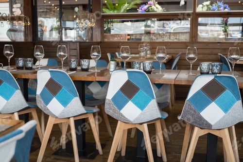 Preview: Modern restaurant interior with stylish blue and gray geometric chairs