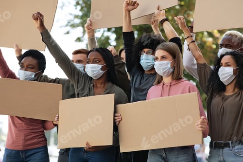 Preview: Enthusiastic young people making riot, holding empty placards