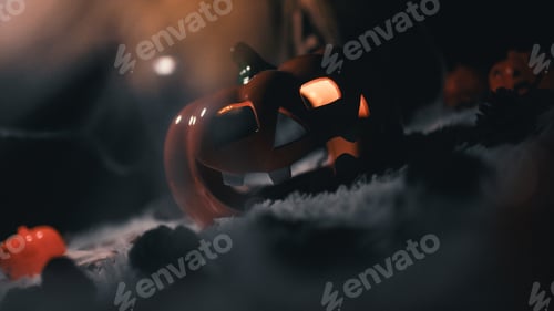 Preview: Damaged flickering halloween pumpkin on the white carpet in the night
