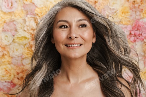 Preview: Smiling mature topless woman standing posing